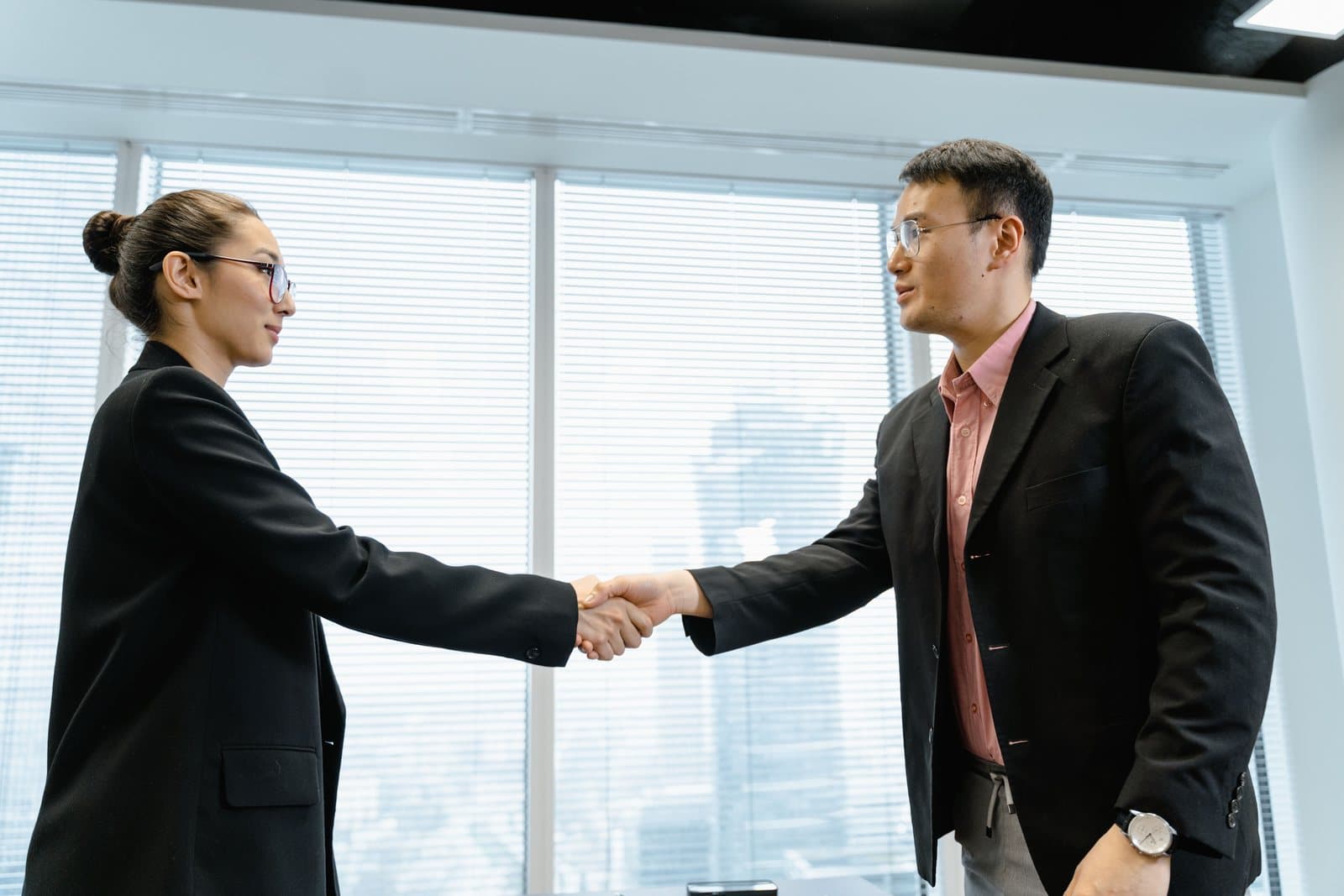 Two professionals shaking hands after a successful placement
